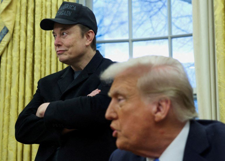 Elon Musk listens to U.S. President Donald Trump speak in the Oval Office of the White House in Washington, D.C., U.S., February 11, 2025. REUTERS/Kevin Lamarque