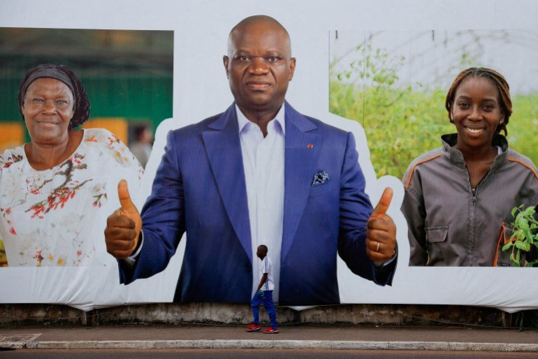 A man walks past a sign showing Brice Clotaire Oligui Nguema, presidential candidate and Gabonese junta leader, ahead of the 2025 Gabonese presidential election in Libreville, Gabon April 7, 2025. REUTERS/Luc Gnago TPX IMAGES OF THE DAY