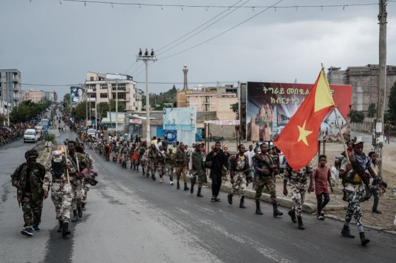 Tigray People's Liberation Front (TPLF) fighters walk in lines towards another field in Mekele, the capital of Tigray region, Ethiopia, on June 30, 2021. Rebel fighters in Ethiopia's war-hit Tigray seized control of more territory on June 29, 2021, one day after retaking the local capital and vowing to drive all "enemies" out of the region. (Photo by Yasuyoshi Chiba / AFP)